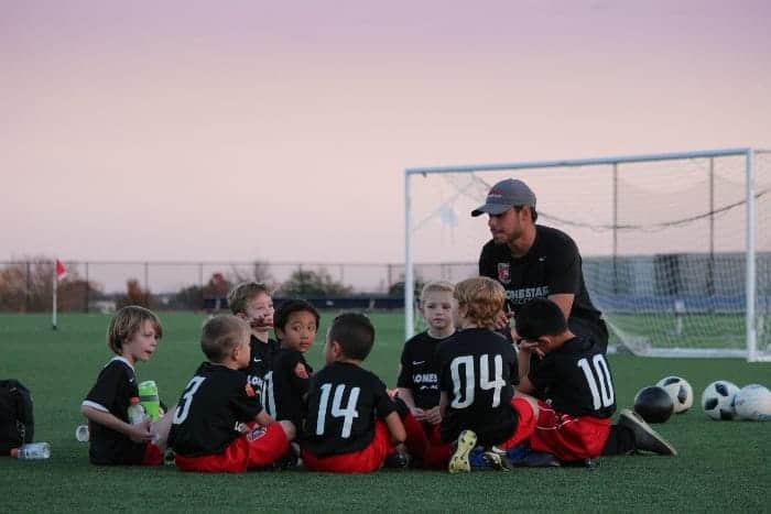 Male soccer coach with kids | How to Become a Youth Sports Coach