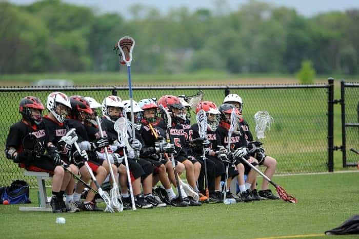 Lacrosse bench with players | What are the Challenges of Coaching Youth Sports?