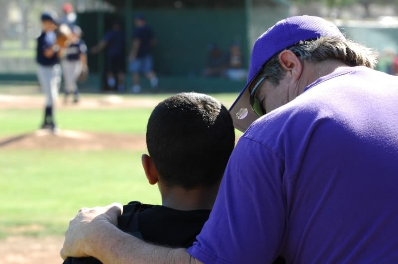 Baseball coach talking to player | How Do You Become a Successful Little League Coach?