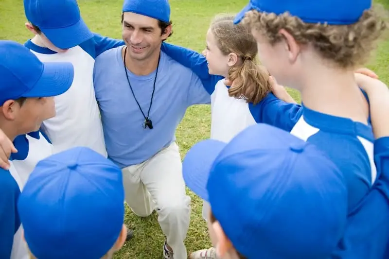 Baseball coach and players | How Do You Become a Successful Little League Coach?