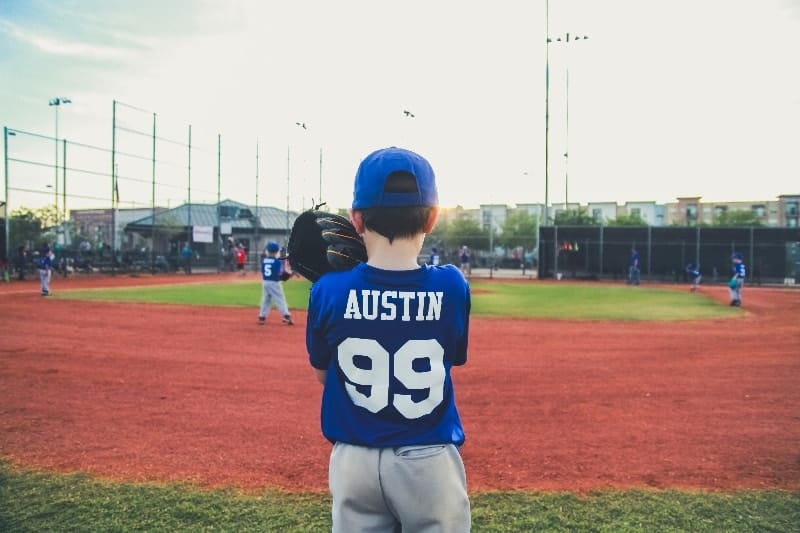 Young boy fielding baseball | How Do You Become a Successful Little League Coach?