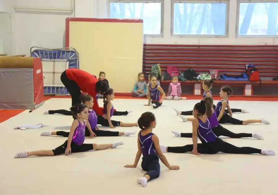 Gymnastics teacher with kids | What Makes a Bad Youth Sports Coach? How to Not Become One