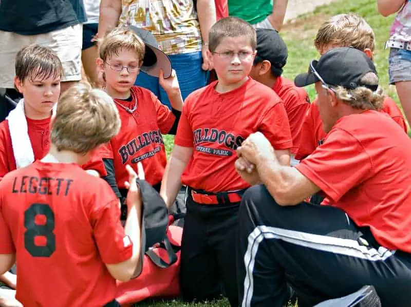 Football coach talking to parents and athletes | Why Do Youth Coaches Bench Good Players?