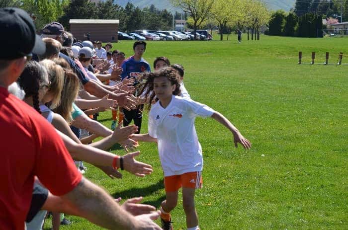 Kids high fiving parents | Why Coaches Should Encourage Parents to Attend Sports Practice