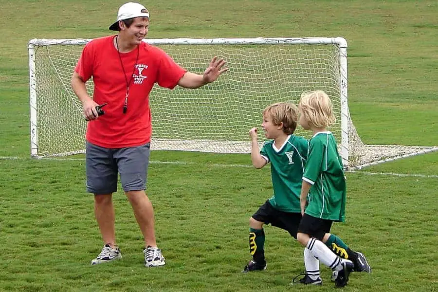 Male coach with youth athletes
