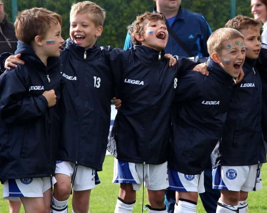 Young boys singing at football